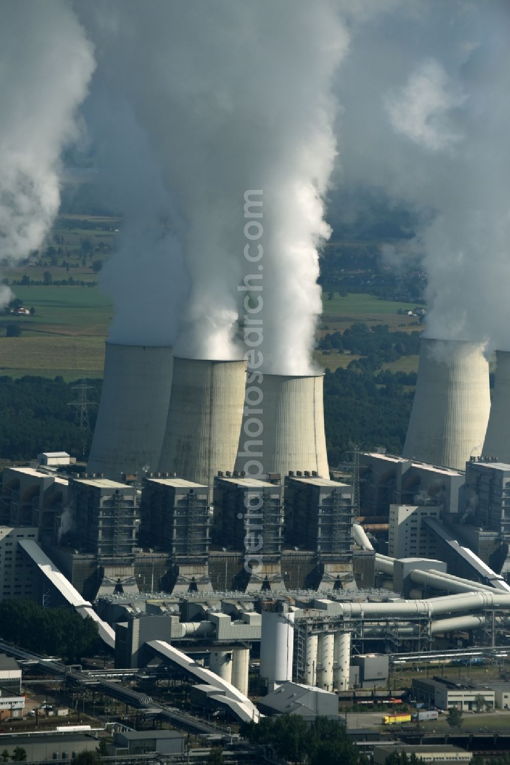 Jänschwalde from the bird's eye view: Clouds of exhaust gas in the cooling towers of the power plant Jaenschwalde, a lignite-fired thermal power plant in southeastern Brandenburg. Power plant operator is to Vattenfall Europe belonging Vattenfall Europe Generation AG, which emerged from VEAG