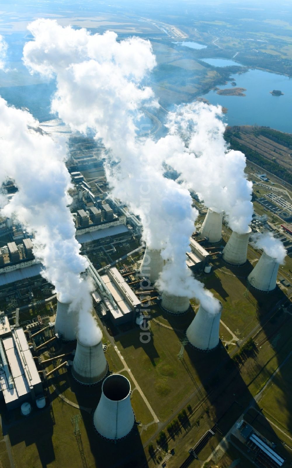 Teichland from the bird's eye view: Clouds of exhaust gas in the cooling towers of the power plant Jaenschwalde, a lignite-fired thermal power plant in southeastern Brandenburg. Power plant operator is to Vattenfall Europe belonging Vattenfall Europe Generation AG, which emerged from VEAG