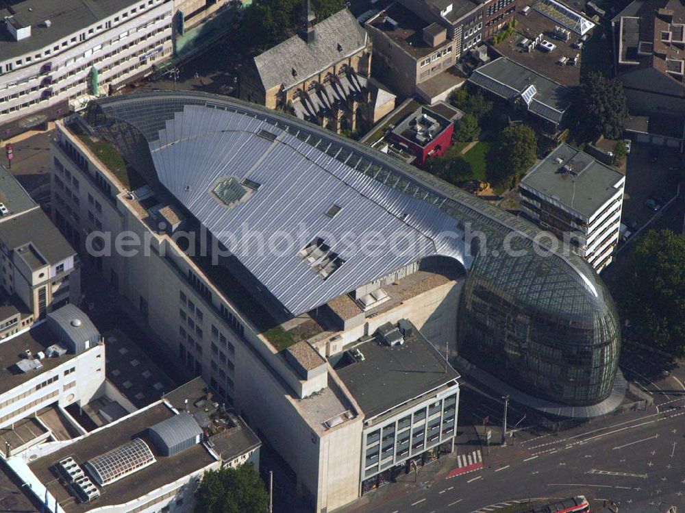 Köln (NRW) from the bird's eye view: Blick auf das neue von der Peek & Cloppenburg KG Düsseldorf erbaute Weltstadthaus in der Kölner Innenstadt. Der Glaspalast mit seinem ovalen Grundriss und seiner schalenförmigen Fassade wurde von dem Architekten Renzo Piano erschaffen. Ab September wird auf rund 14.200 Quadratmetern Verkaufsfläche und fünf Etagen Damen-, Herren- und Kindermode vertrieben. Peek & Cloppenburg KG, Weltstadthaus, Köln - Schildergasse, 50667 Köln, Schildergasse 65-67, 0221 - 453900