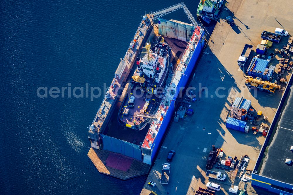 Aerial image Cuxhaven - Shipyard area with the Tug Buetzfleth on the floating dock in the harbor basin of Cuxhaven in the state Lower Saxony, Germany