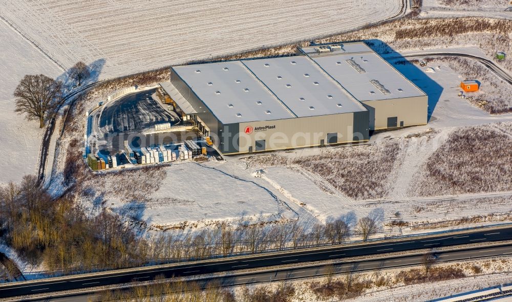 Meschede from above - Winterly snowy building and production hall of the company AstroPlast beneath the motorway A 46 in Meschede in the state North Rhine-Westphalia