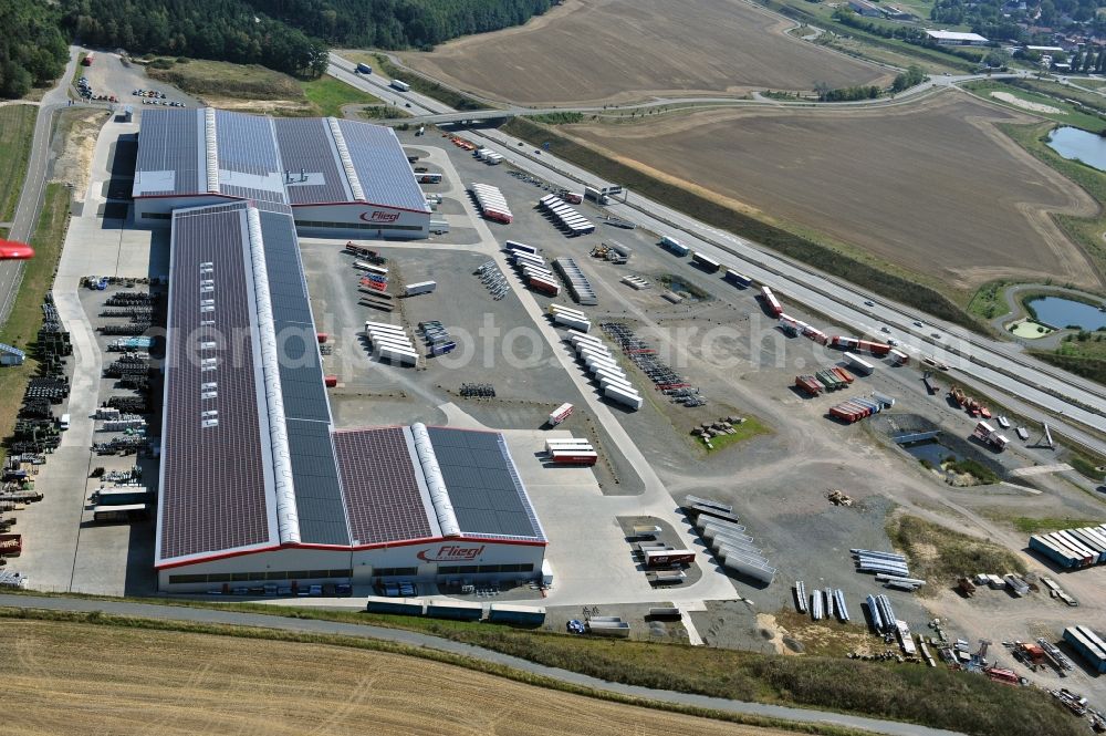 Aerial image Triptis - Manufacturing location of utility vehicle company Fliegl at Oberpoellnitzer Strasse in town Triptis, Thuringia. Fliegl-group has domestic and abroad production sites for vehicle construction, structural engineering and agricultural engineering. It is one of the biggest companies of this type in Germany