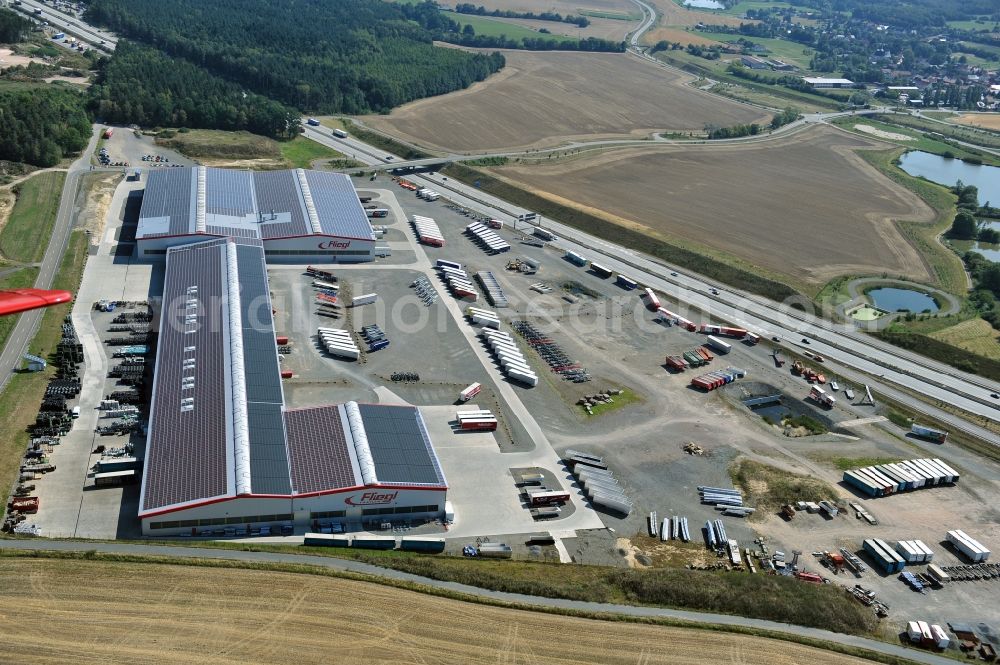Aerial photograph Triptis - Manufacturing location of utility vehicle company Fliegl at Oberpoellnitzer Strasse in town Triptis, Thuringia. Fliegl-group has domestic and abroad production sites for vehicle construction, structural engineering and agricultural engineering. It is one of the biggest companies of this type in Germany