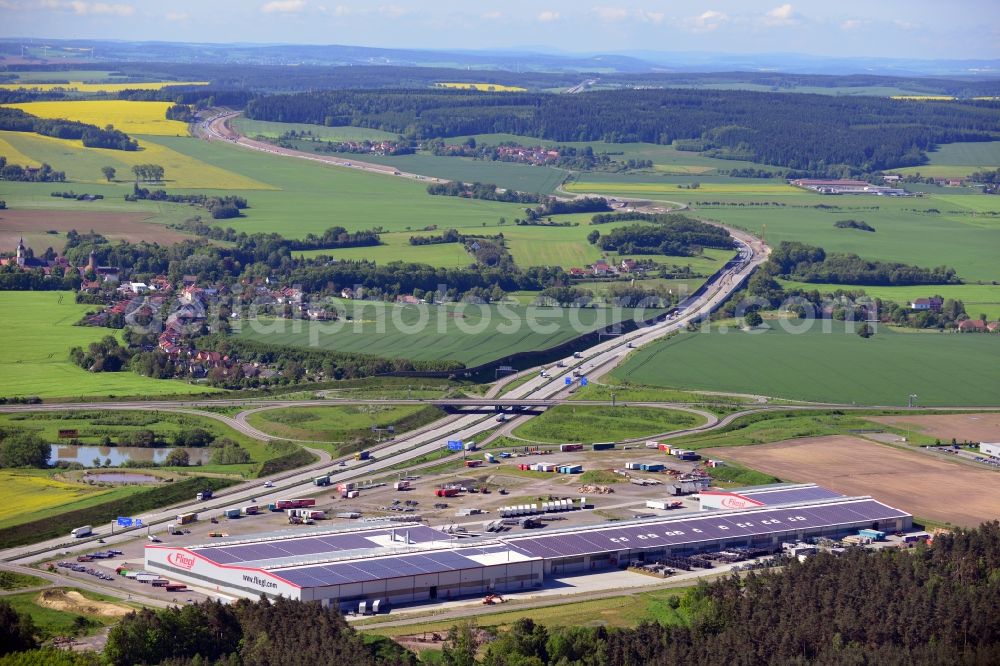 Triptis from above - Manufacturing location of utility vehicle company Fliegl at Oberpoellnitzer Strasse in town Triptis, Thuringia. Fliegl-group has domestic and abroad production sites for vehicle construction, structural engineering and agricultural engineering. It is one of the biggest companies of this type in Germany