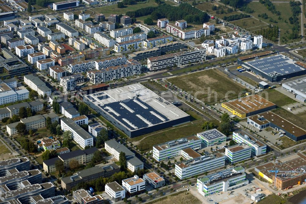 Berlin from the bird's eye view: Building and production halls on the premises of Freudenberg Dichtungs- and Schwingungstechnik GmbH on Gross-Berliner Donm in the district Adlershof in Berlin, Germany