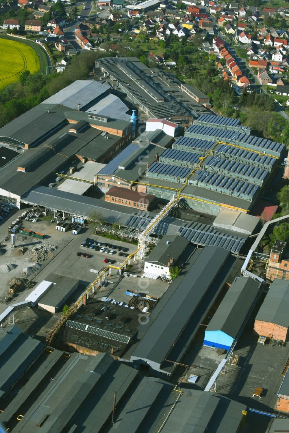 Hettstedt from the bird's eye view: Building and production halls on the premises of Mansfelof Aluminiumwerk GmbH on Lichtloecherberg in the district Grossoerner in Hettstedt in the state Saxony-Anhalt, Germany