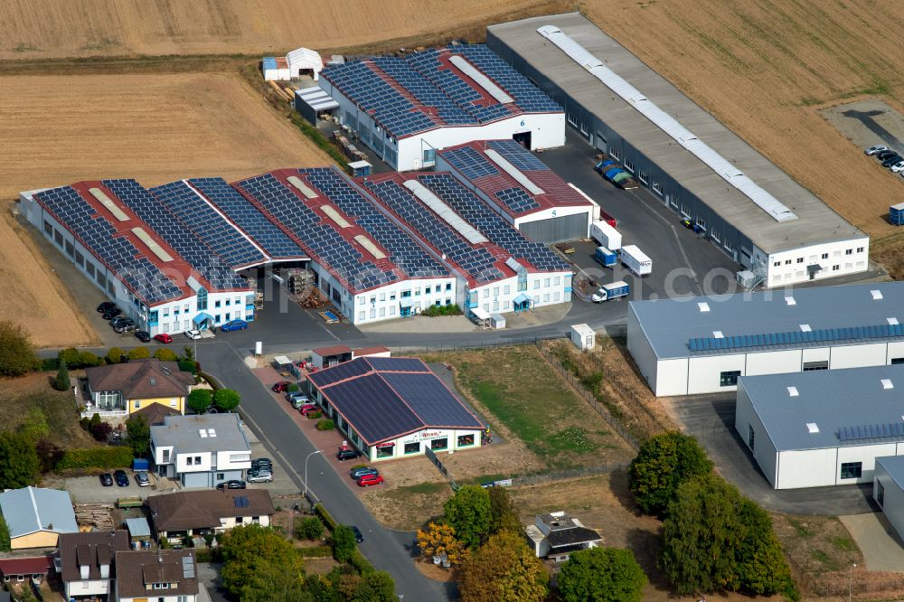 Aerial image Steinfeld - Building and production halls on the premises of SCHMELZMETALL Deutschland GmbH and of INHATEC GmbH & Co. KG on Raiffeisenstrasse in the district Hausen in Steinfeld in the state Bavaria, Germany