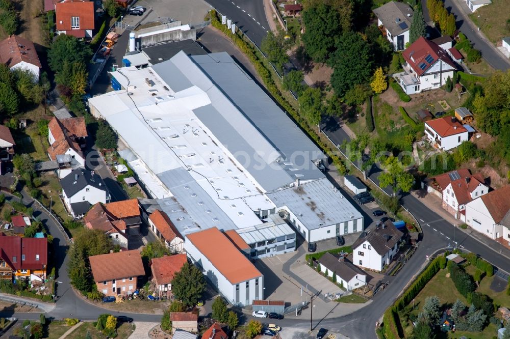 Aura im Sinngrund from above - Building and production halls on the premises of the Viant Aura GmbH along the Staatsstrasse on Struthberg in the district Deutelbach in Aura im Sinngrund in the state Bavaria, Germany