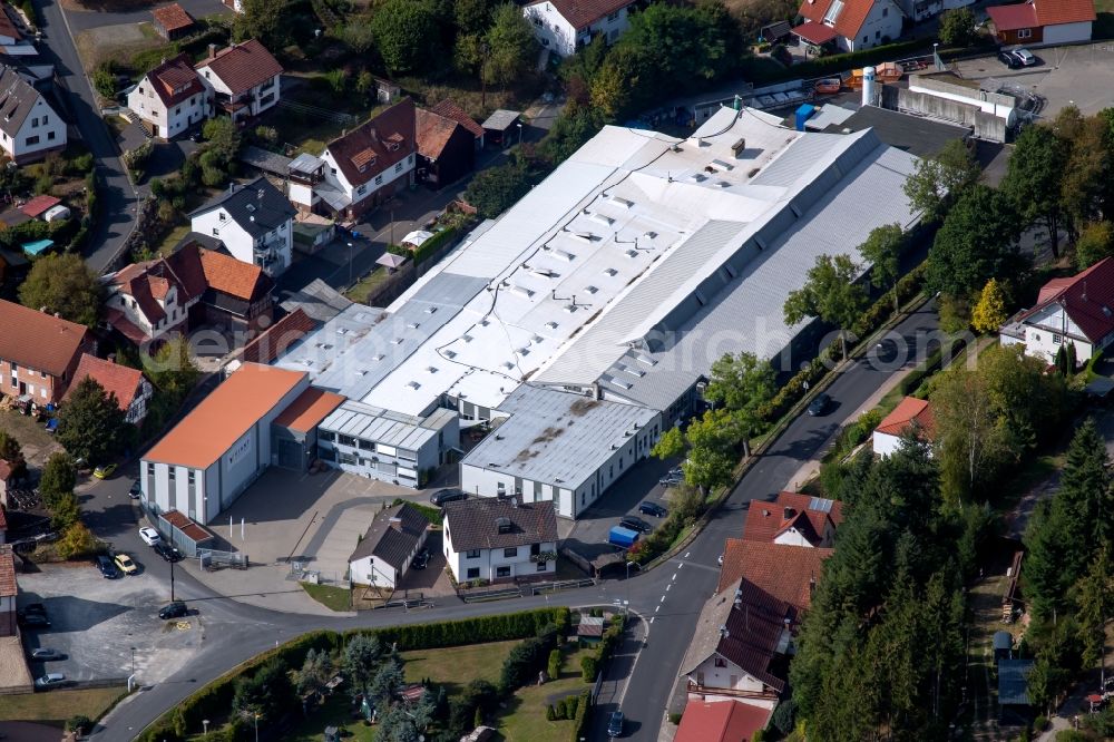 Aura im Sinngrund from the bird's eye view: Building and production halls on the premises of the Viant Aura GmbH along the Staatsstrasse on Struthberg in the district Deutelbach in Aura im Sinngrund in the state Bavaria, Germany