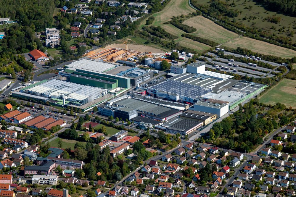 Marktheidenfeld from above - Commercial area with the factory premises of WAREMA Renkhoff SE and the extension - new building - construction site on the buildings and production halls of the factory premises of Procter & Gamble Manufacturing GmbH Am Kornfeld - Baumhofstrasse in Marktheidenfeld in the state Bavaria, Germany