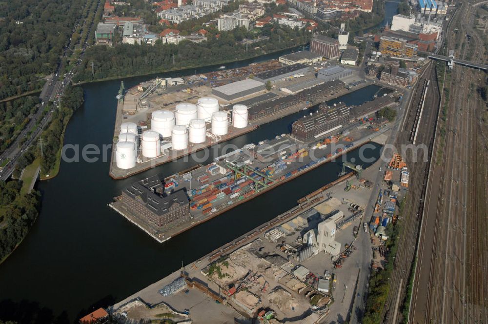 Aerial photograph Berlin - Der Berliner Westhafen ist ein Binnenhafen im Ortsteil Moabit des Bezirks Mitte. Der Westhafen ist mit einer Fläche von 430.000 m² der größte Hafen der Stadt und ein bedeutender Umschlag- und Lagerplatz für die Binnenschifffahrt. Die Berliner Hafen-und Lagerhausgesellschaft mbH, kurz BEHALA genannt, betreibt in Berlin mehrere Binnenhäfen mit den dazugehörigen Lagerhäusern, dem Güterumschlag, einer Bauschuttentsorgung, den Hafenbahnen, und die Vermietung von Immobilien auf den Hafengeländen. Sie ist ein Eigenbetrieb der Stadt Berlin. Weitere Informationen unter