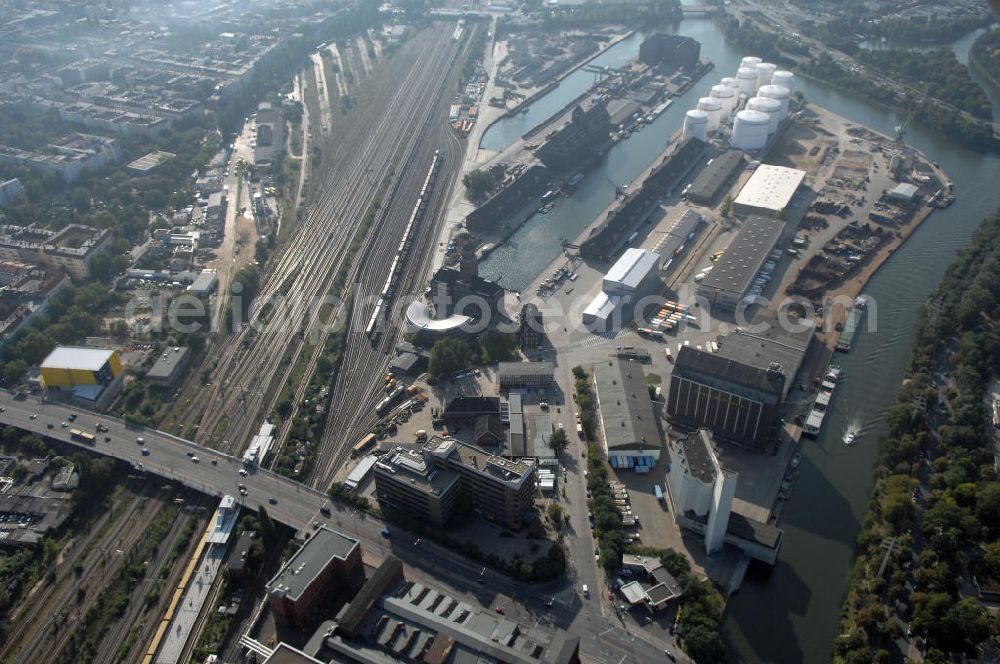 Aerial photograph Berlin - Der Berliner Westhafen ist ein Binnenhafen im Ortsteil Moabit des Bezirks Mitte. Der Westhafen ist mit einer Fläche von 430.000 m² der größte Hafen der Stadt und ein bedeutender Umschlag- und Lagerplatz für die Binnenschifffahrt. Die Berliner Hafen-und Lagerhausgesellschaft mbH, kurz BEHALA genannt, betreibt in Berlin mehrere Binnenhäfen mit den dazugehörigen Lagerhäusern, dem Güterumschlag, einer Bauschuttentsorgung, den Hafenbahnen, und die Vermietung von Immobilien auf den Hafengeländen. Sie ist ein Eigenbetrieb der Stadt Berlin. Weitere Informationen unter