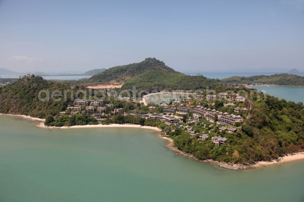 Ratsada from the bird's eye view: The Westin Hotel in Ratsada is located on the island of Phuket in Thailand on the beach and wooded hillsides between palms and overlooking the bay from Phuket Town