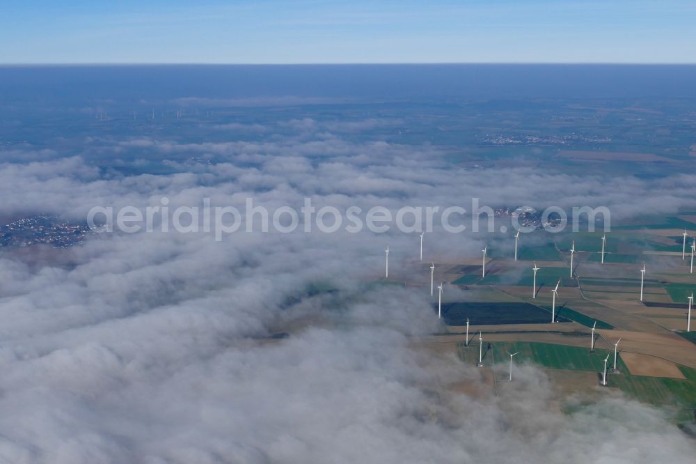 Warburg from above - Weather-induced wind energy installations embedded in a fog layer on a field in Warburg in the state North Rhine-Westphalia, Germany