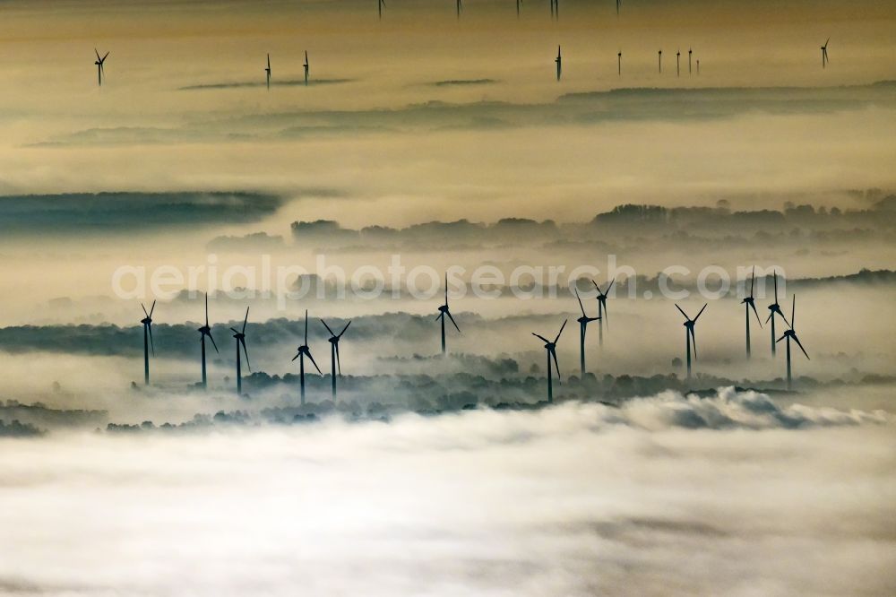 Lüchow from the bird's eye view: Weather-induced wind energy installations embedded in a fog layer in Luechow in the state Lower Saxony, Germany