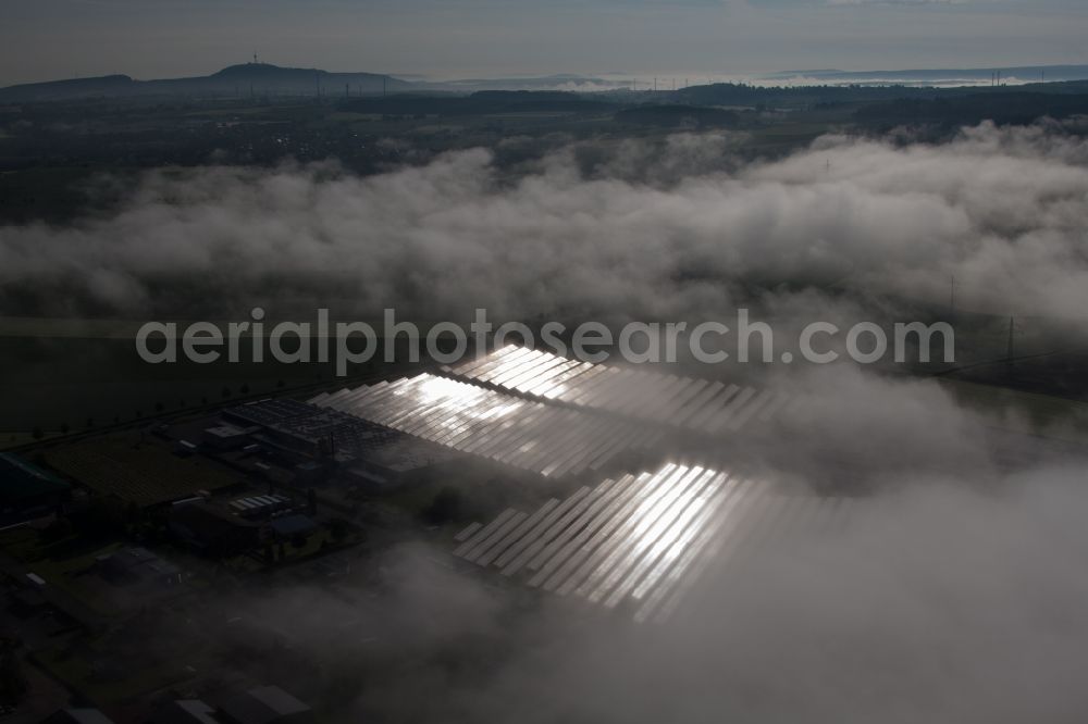 Aerial image Marienmünster - Weather-related panel rows of the photovoltaic plant of the solar park or solar power plant in the district Bredenborn in Marienmuenster in the state North Rhine-Westphalia