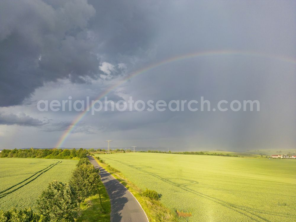 Krebs from above - Haze and precipitation conditions with rainbow formation on a field on street Krebs in Krebs in the state Saxony, Germany