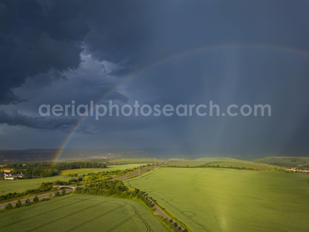 Krebs from the bird's eye view: Haze and precipitation conditions with rainbow formation on a field on street Krebs in Krebs in the state Saxony, Germany