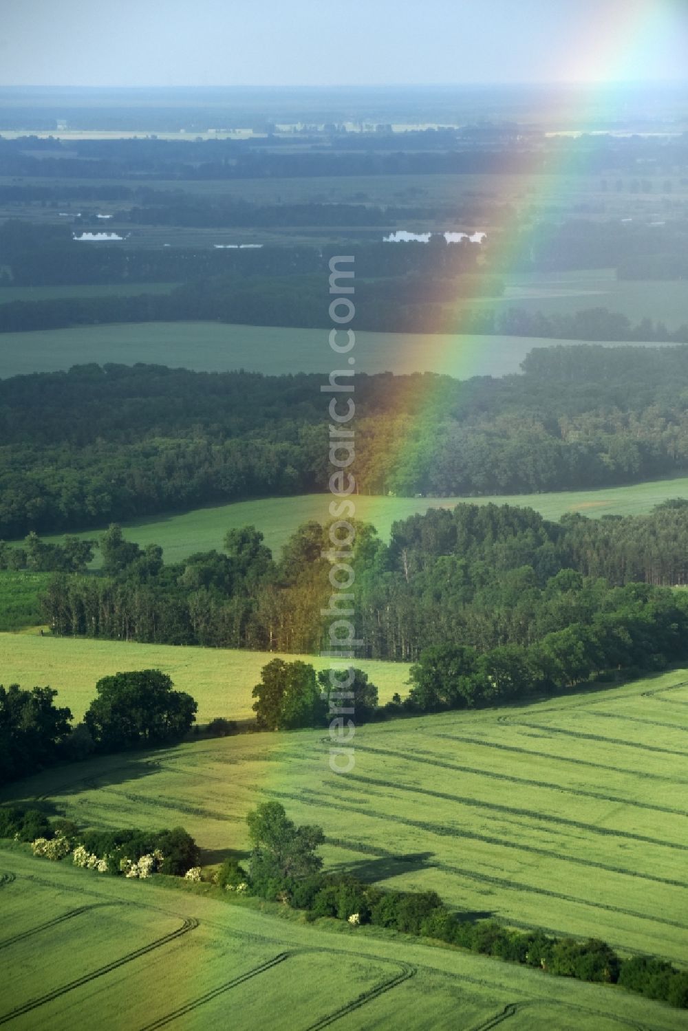 Fehrbellin from the bird's eye view: Haze and precipitation conditions with rainbow formation in Fehrbellin in the state Brandenburg