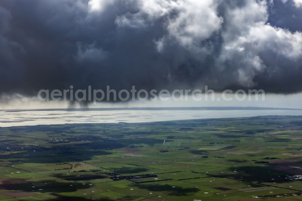 Oevenum from the bird's eye view: Weather conditions with cloud formation ueber landwirtschaftlichen Flaechen of Insel Foehr in Oevenum North Friesland in the state Schleswig-Holstein, Germany