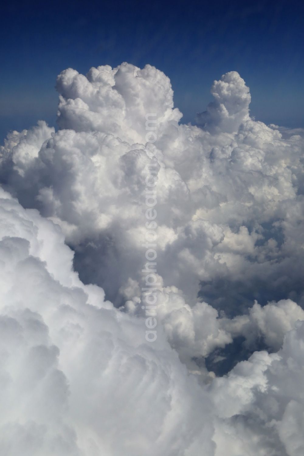 Badenweiler from above - Weather conditions with cloud formation over the Black Forest in Germany. Cumulus clouds and thunderclouds are rising into the blue sky