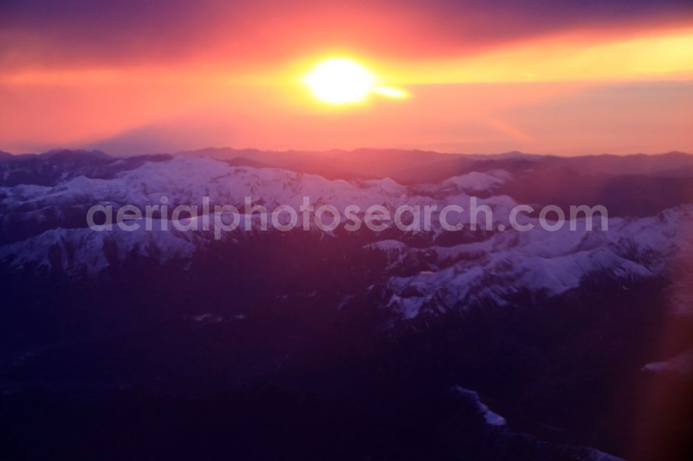 Aime from the bird's eye view: Weather situation with cloud formation and light reflections at sunrise Above the mountain group of the Alps in Aime in Auvergne-Rhone-Alpes, France