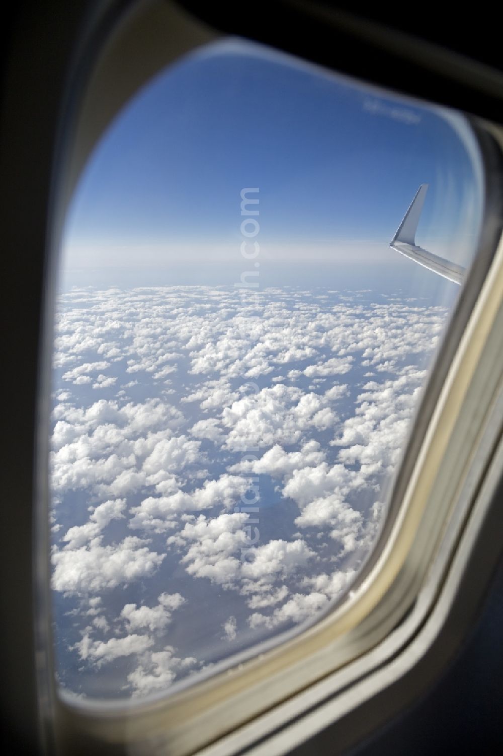 Pollenca from the bird's eye view: Weather conditions with cloud formation from the window of a passenger aircraft in Pollenca in Balearic Islands, Spain