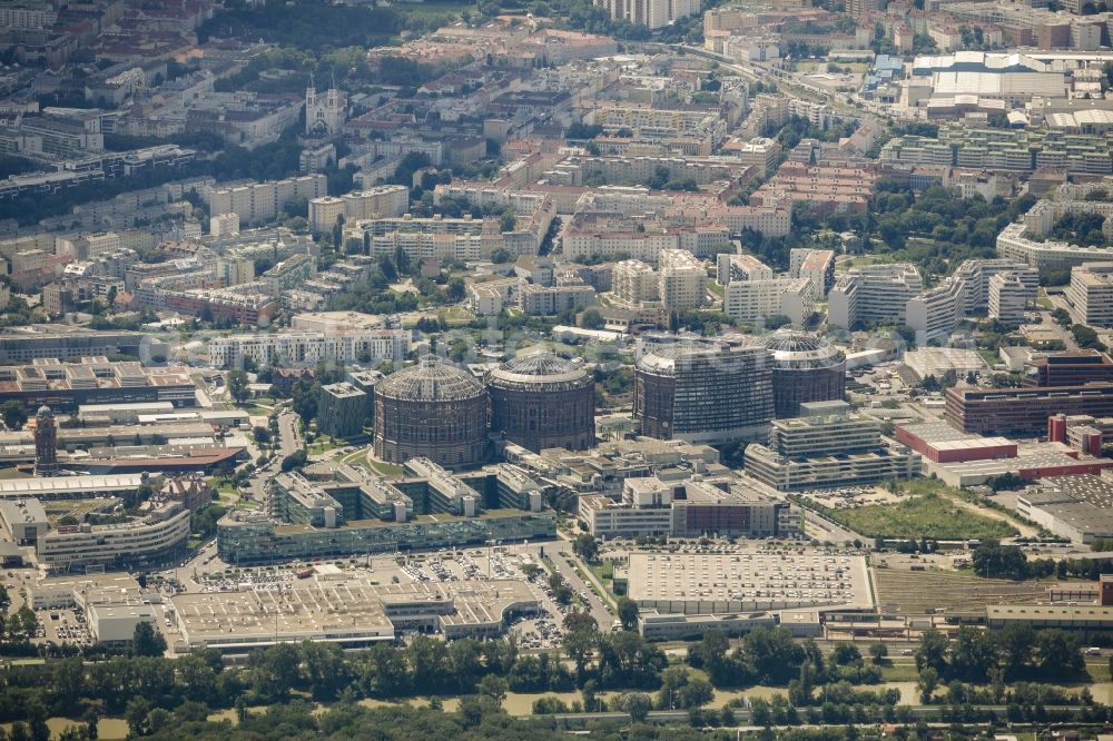 Wien from the bird's eye view: Gasometer Vienna with the shopping mall Gasometer City in the district of Simmering in Vienna in Austria. The four former gas tanks and their surrounding area have been converted to a residential and business quarter