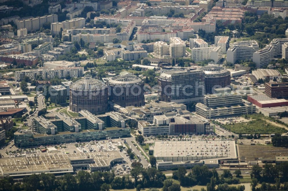 Aerial photograph Wien - Gasometer Vienna with the shopping mall Gasometer City in the district of Simmering in Vienna in Austria. The four former gas tanks and their surrounding area have been converted to a residential and business quarter