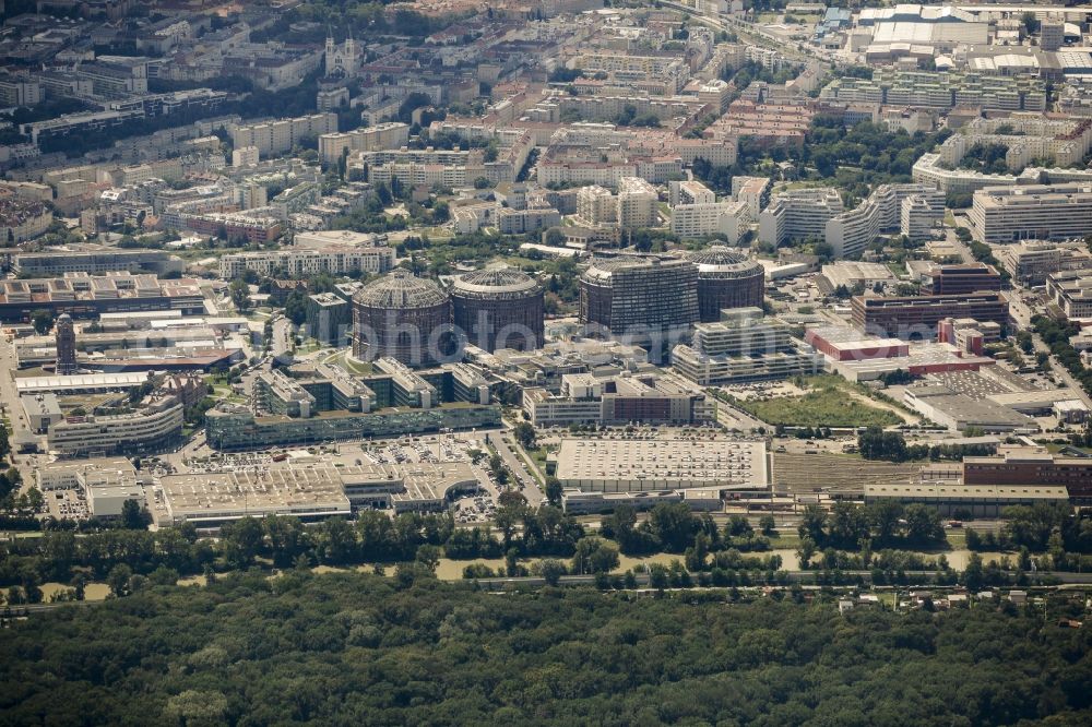 Wien from above - Gasometer Vienna with the shopping mall Gasometer City in the district of Simmering in Vienna in Austria. The four former gas tanks and their surrounding area have been converted to a residential and business quarter