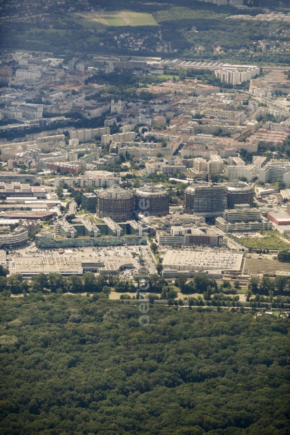 Wien from the bird's eye view: Gasometer Vienna with the shopping mall Gasometer City in the district of Simmering in Vienna in Austria. The four former gas tanks and their surrounding area have been converted to a residential and business quarter