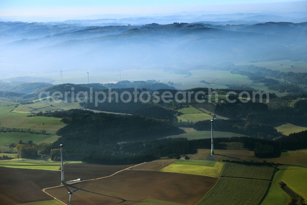 Aerial photograph Eslohe - High fog-like cloud layers imposed by the source view of a wind turbine for electricity generation in Eslohe in North Rhine-Westphalia