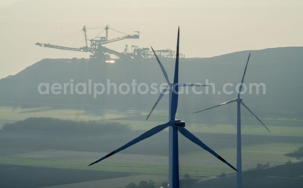 Titz from above - Wind turbine windmills on a field in the district Bettenhoven in Titz in the state North Rhine-Westphalia. In the background, the brown coal mine opencast mine Hambach - Etzweiler of RWE Power AG