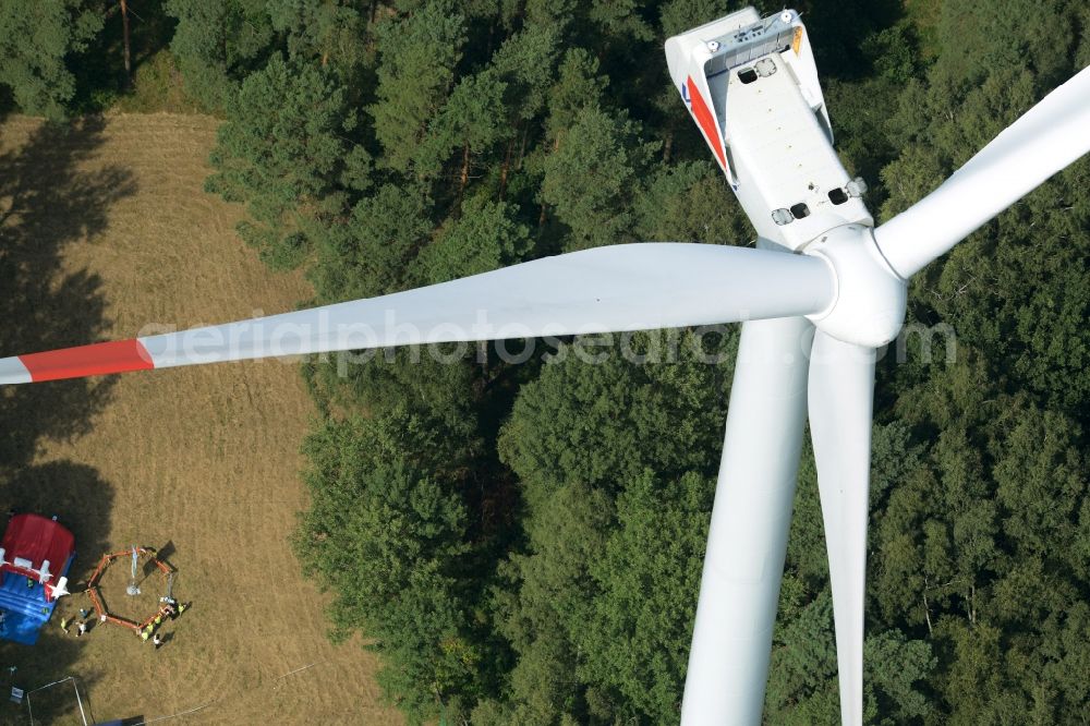 Sallgast from above - Wind turbine above the opening party of the forest- windpark Goellnitz-Lieskau-Rehain in Sallgast in the state of Brandenburg. Developed by UKA the largest forest windpark of Germany opens with tents, drinks and stands on the foot of a turbine of Vestas in a forest