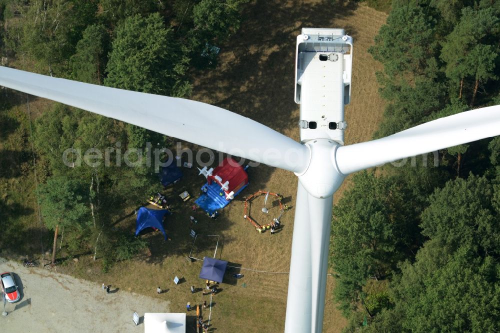 Aerial image Sallgast - Wind turbine above the opening party of the forest- windpark Goellnitz-Lieskau-Rehain in Sallgast in the state of Brandenburg. Developed by UKA the largest forest windpark of Germany opens with tents, drinks and stands on the foot of a turbine of Vestas in a forest