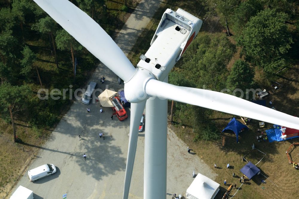 Sallgast from above - Wind turbine above the opening party of the forest- windpark Goellnitz-Lieskau-Rehain in Sallgast in the state of Brandenburg. Developed by UKA the largest forest windpark of Germany opens with tents, drinks and stands on the foot of a turbine of Vestas in a forest