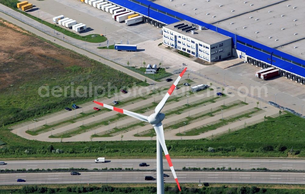 Aerial photograph Hörselgau - At the motorway A4 at the spatial location Hoerselgau is a 2000kW wind turbine in close proximity to the logistics center of the company RHENUS