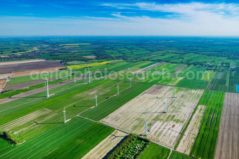 Oederquart from the bird's eye view: Agricultural land and fields with wind turbines Hammelwoerden in Oederquart in the state Lower Saxony, Germany