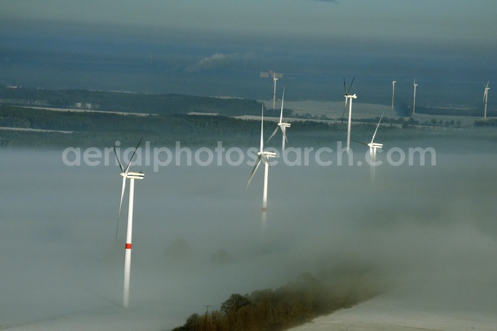 Aerial image Werneuchen - Wind turbine windmills on a winterly snow and fog covered field in Werneuchen in the state of Brandenburg