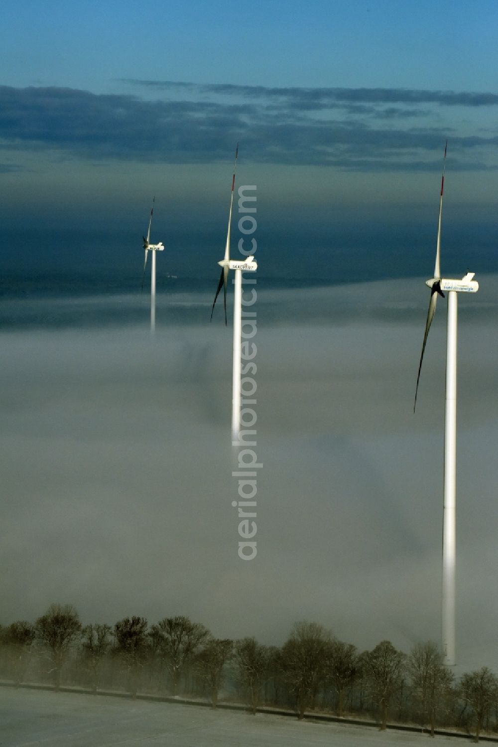 Aerial image Werneuchen - Wind turbine windmills of Notus, Saxovent and Stahl Energy on a winterly snow and fog covered field in Werneuchen in the state of Brandenburg