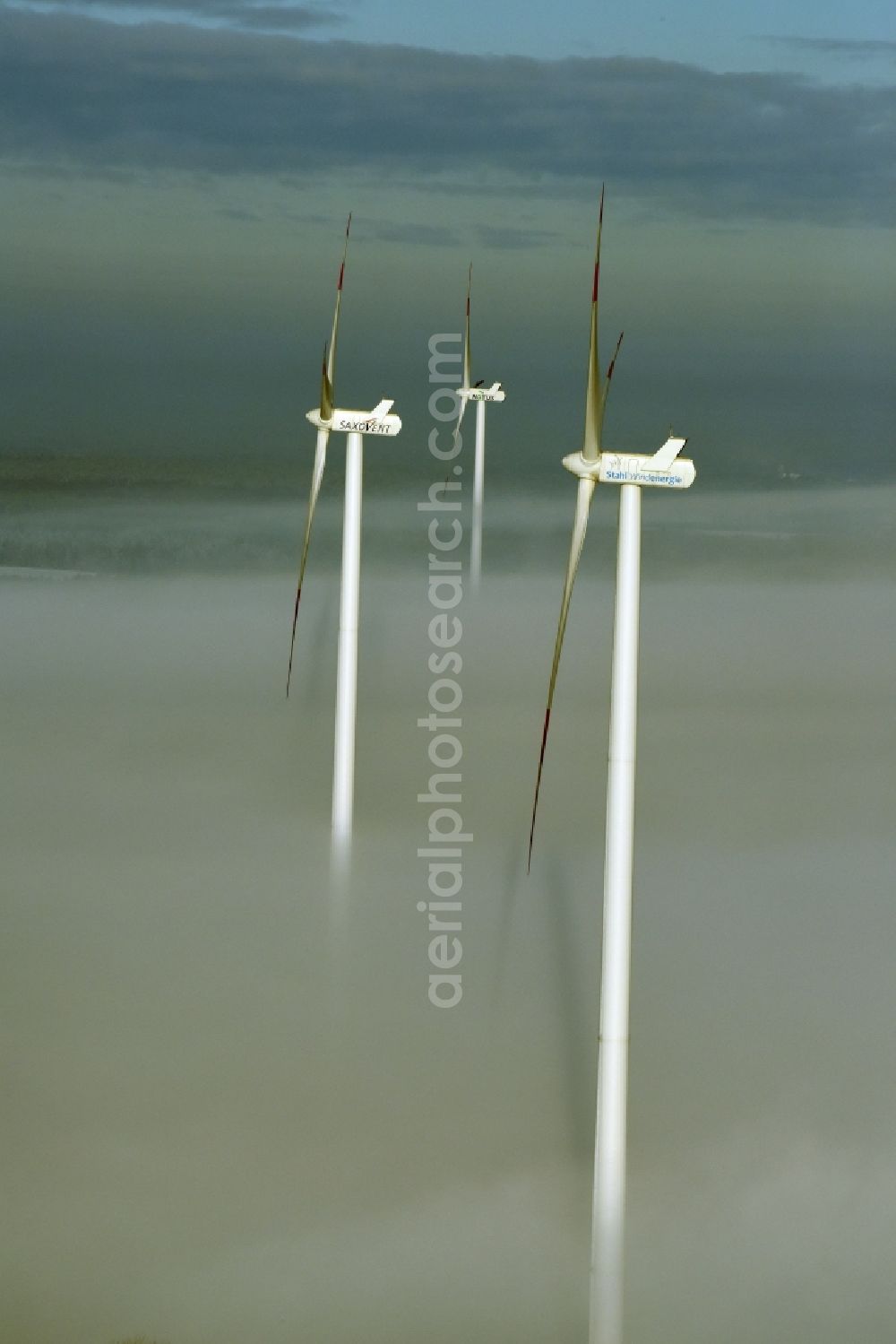 Aerial photograph Werneuchen - Wind turbine windmills of Notus, Saxovent and Stahl Energy on a winterly snow and fog covered field in Werneuchen in the state of Brandenburg