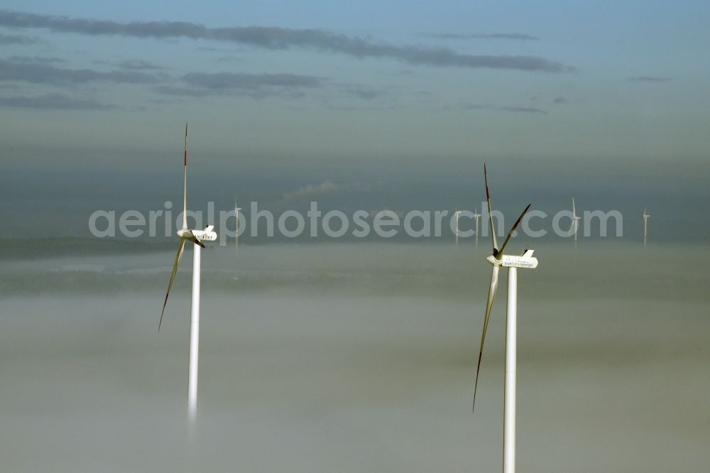 Aerial photograph Werneuchen - Wind turbine windmills of Saxovent and Stahl Energy on a winterly snow and fog covered field in Werneuchen in the state of Brandenburg