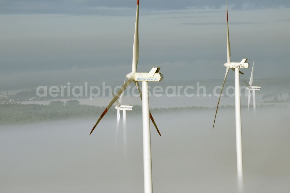 Aerial image Beiersdorf-Freudenberg - Wind turbine windmills of Vestas, Saxovent and Stahl Energy on a winterly snow and fog covered field in Beiersdorf-Freudenberg in the state of Brandenburg