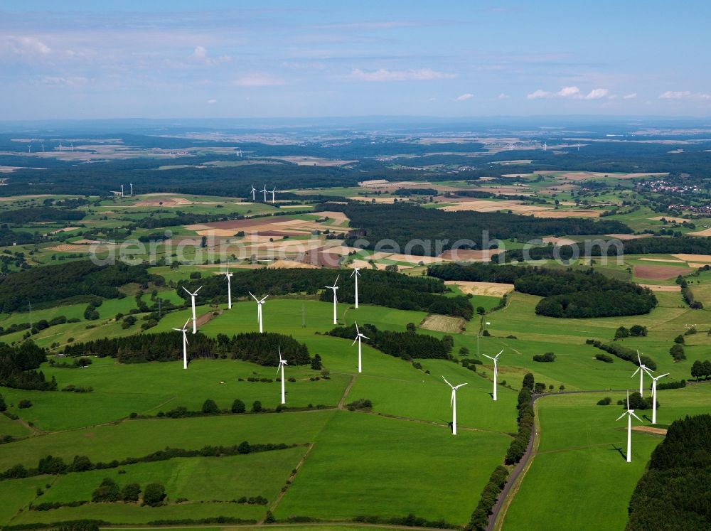 Romrod from above - Wind engines and turbines near Romrod in the state of Hessen. The big wheels are located in the area of the remains of the Vogelsberg mountain. Overview of these landscapes and the strategic placing of the turbines for energy generation