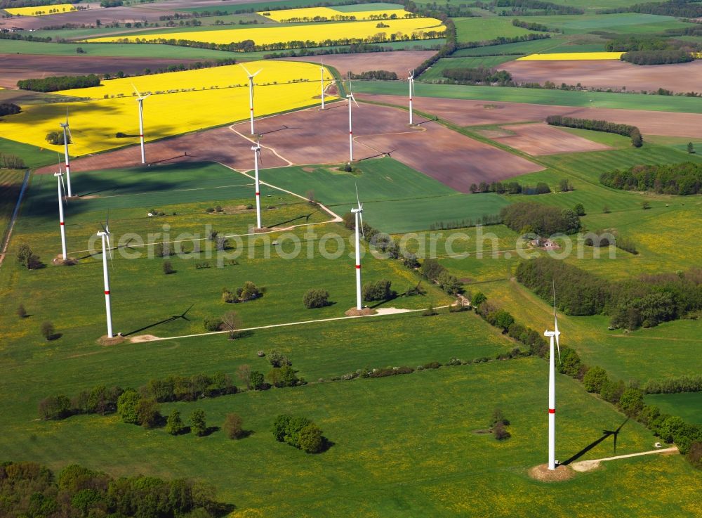 Schwerin from above - Wind power wheels and turbines in the county district of Nordwestmecklenburg in the state of Mecklenburg-Vorpommern. The turbines are placed between fields. Overview of the agricultural structures as well as the wheels used to create energy