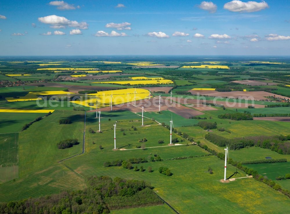 Schwerin from the bird's eye view: Wind power wheels and turbines in the county district of Nordwestmecklenburg in the state of Mecklenburg-Vorpommern. The turbines are placed between fields. Overview of the agricultural structures as well as the wheels used to create energy