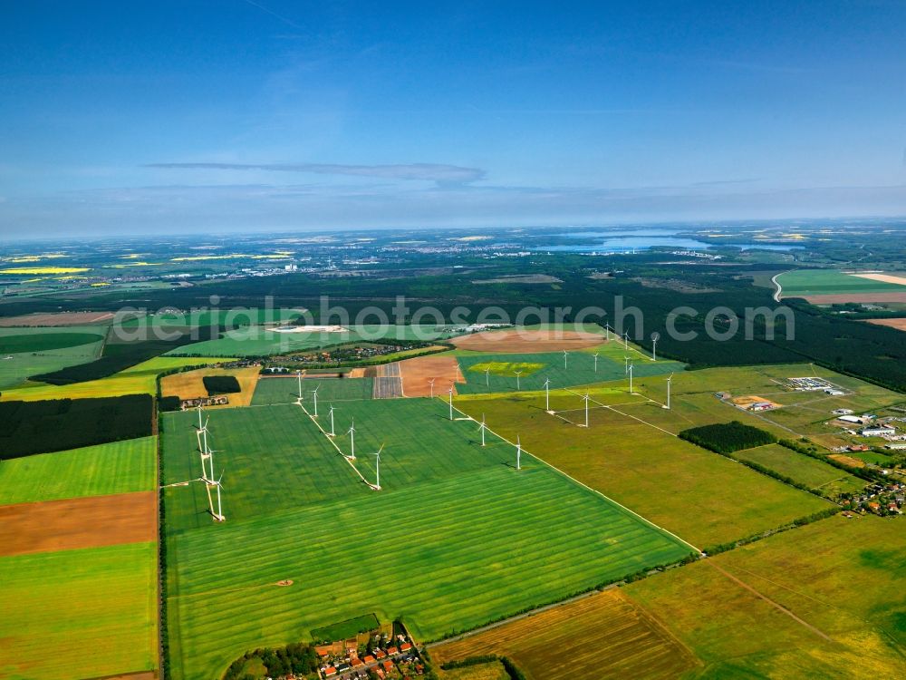 Aerial image Schwerin - Wind power wheels and turbines in the county district of Nordwestmecklenburg in the state of Mecklenburg-Vorpommern. The turbines are placed between fields. Overview of the agricultural structures as well as the wheels used to create energy