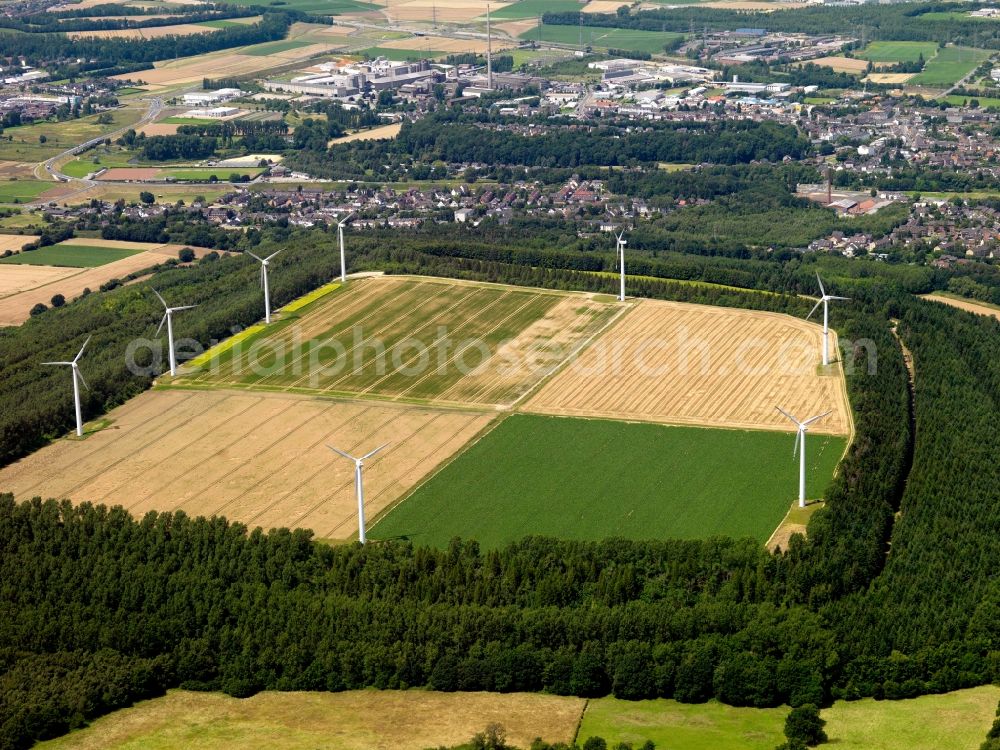 Aerial image Langerwehe - Wind power wheels and turbines in the county district of Langerwehe in the state of North Rhine-Westphalia. The turbines are placed between fields. Overview of the agricultural structures as well as the wheels used to create energy