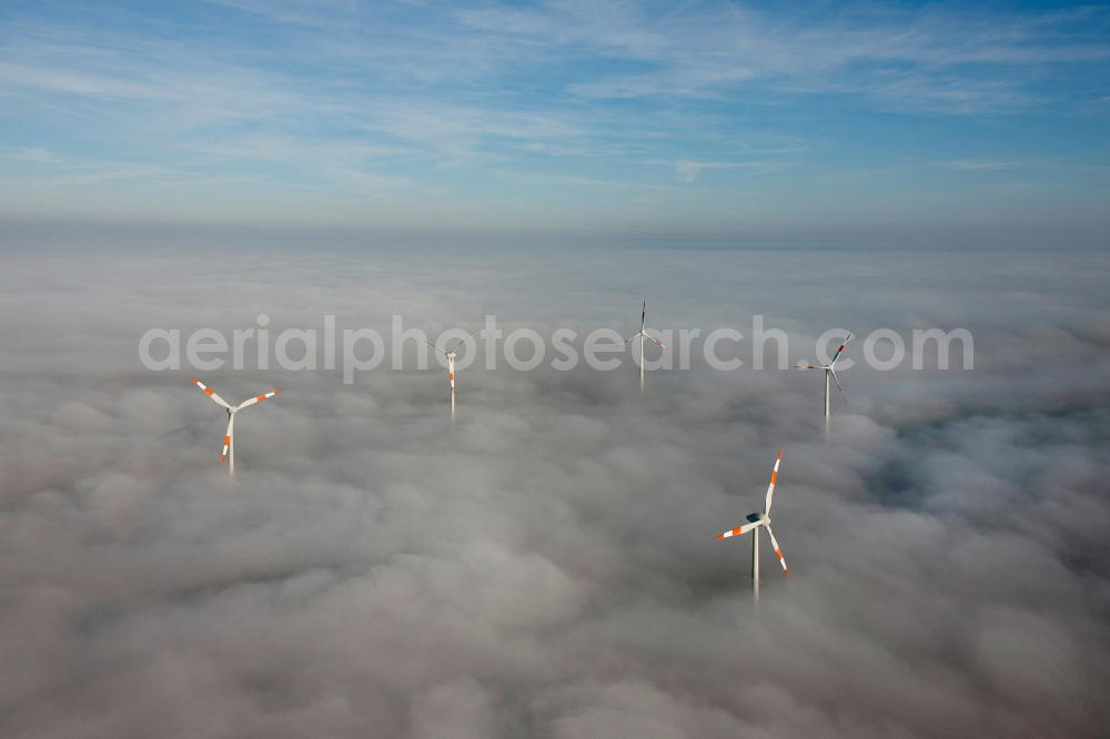 Bretleben from above - Windkrafträder bei Herbstwetter in einer Hochnebel - Wolkendecke bei Bretleben in Thüringen. Wind turbines in the autumn weather in a high fog - cloud cover at Bretleben in Thuringia.