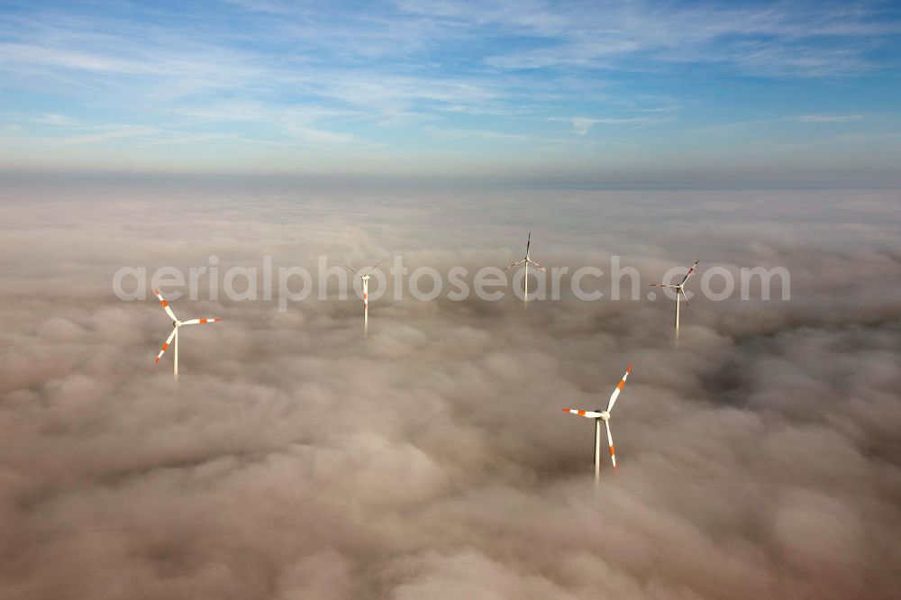 Bretleben from the bird's eye view: Windkrafträder bei Herbstwetter in einer Hochnebel - Wolkendecke bei Bretleben in Thüringen. Wind turbines in the autumn weather in a high fog - cloud cover at Bretleben in Thuringia.